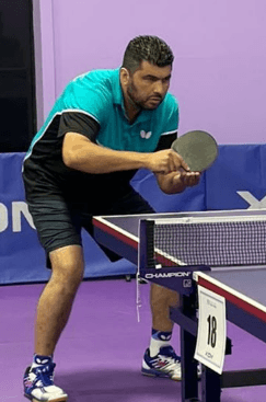 Coach David Bonilla serving
